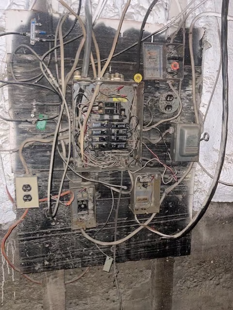 an electrical panel in a home's basement.