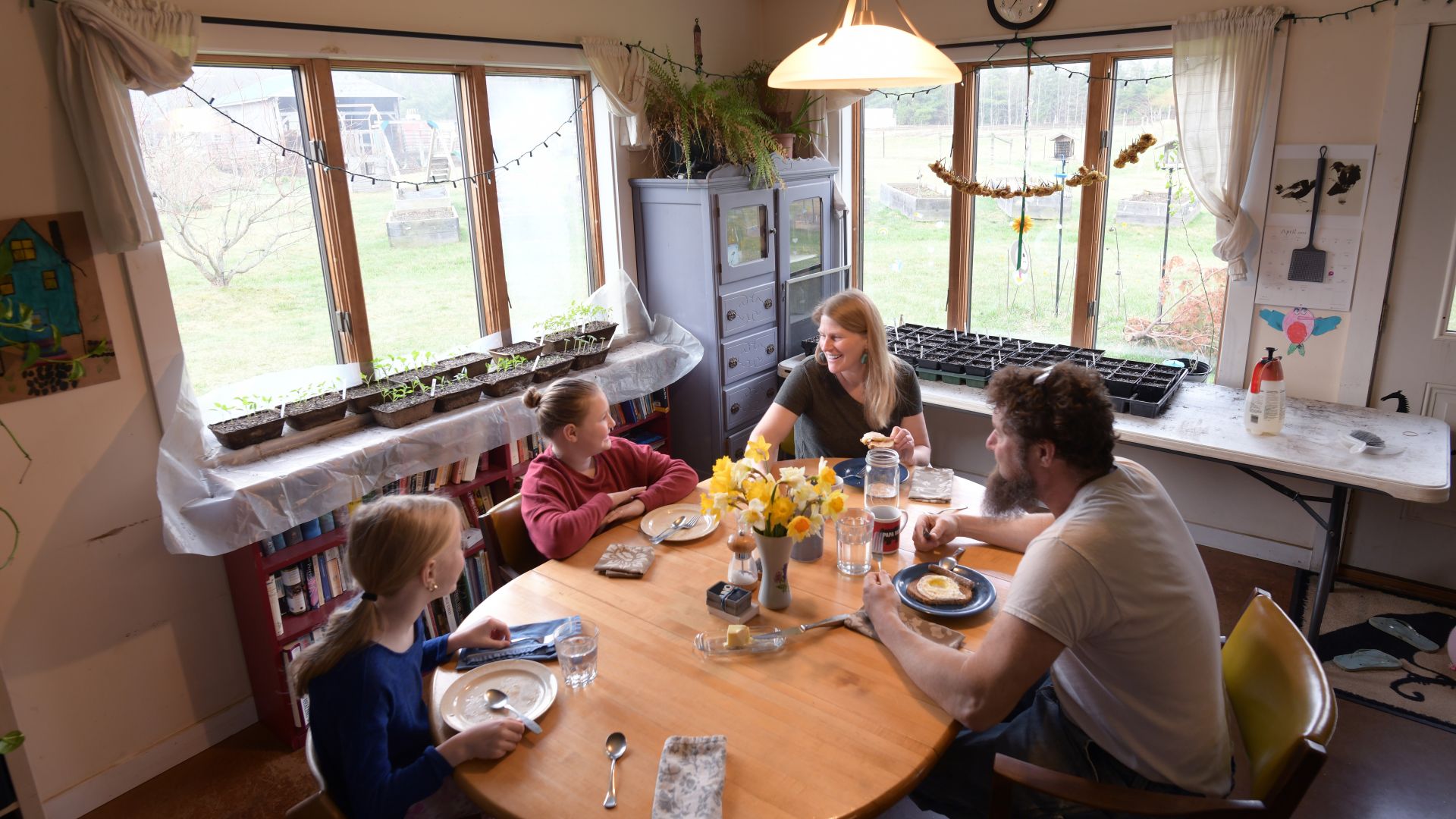 The Sinsi family gathers around a table during a meal.