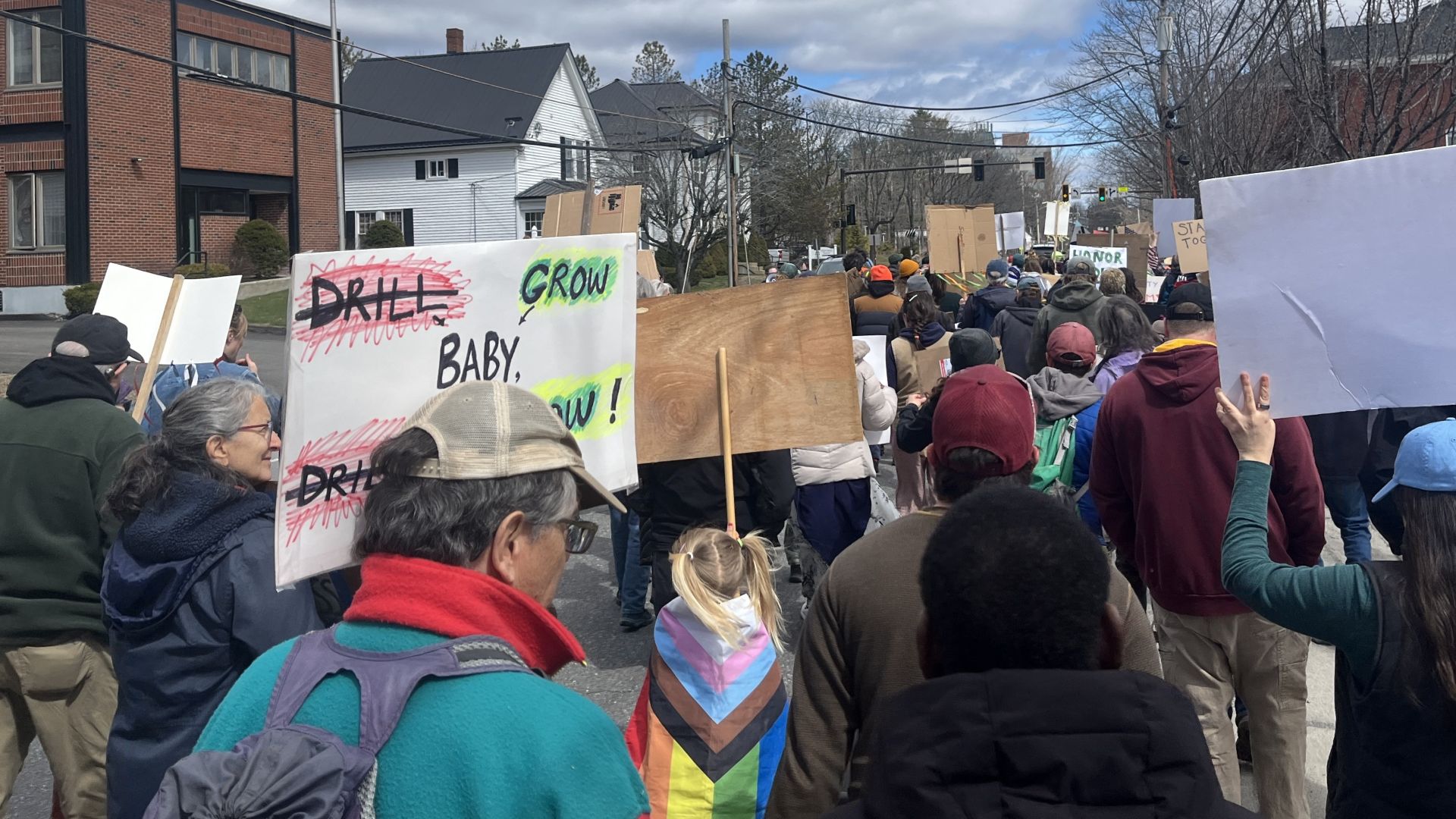 demonstrators walk through a street.