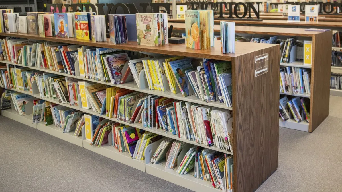 books line the shelves of a library.