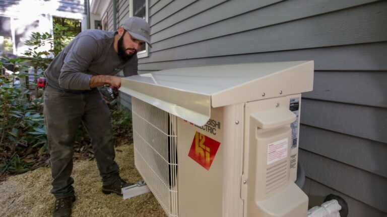 technician installing a cap to protect a heat pump