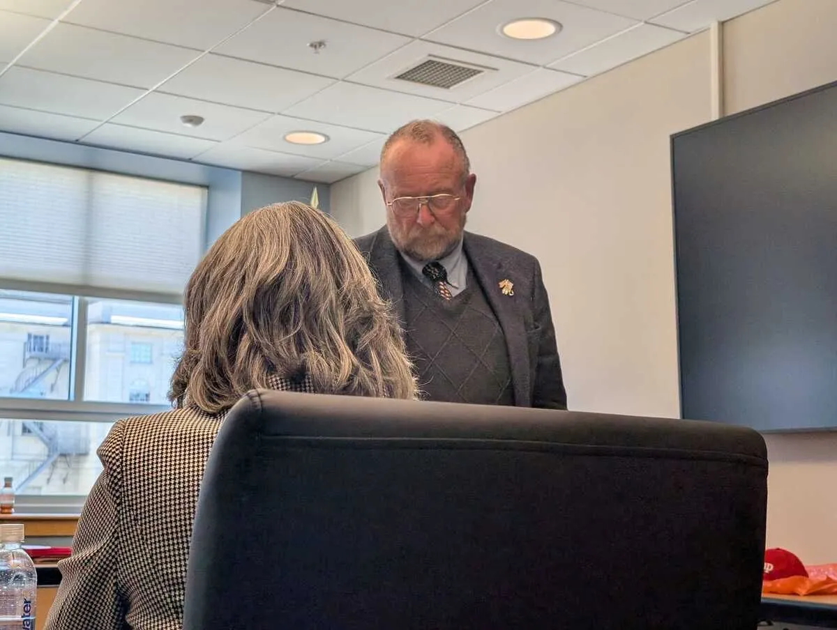 David Corbett walks up to a table