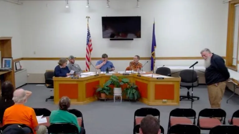 Members of the Skowhegan select board listen to John Youney.