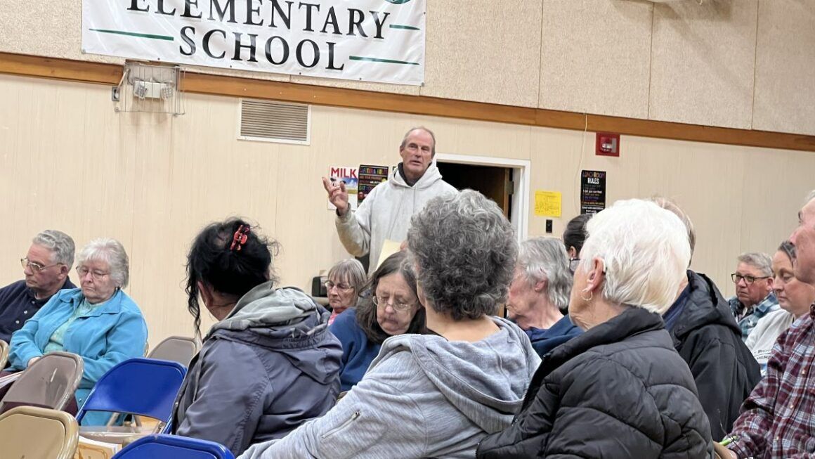 Sam Hunkler stands in the crowd while speaking.