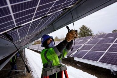 a man works on wiring solar panels.