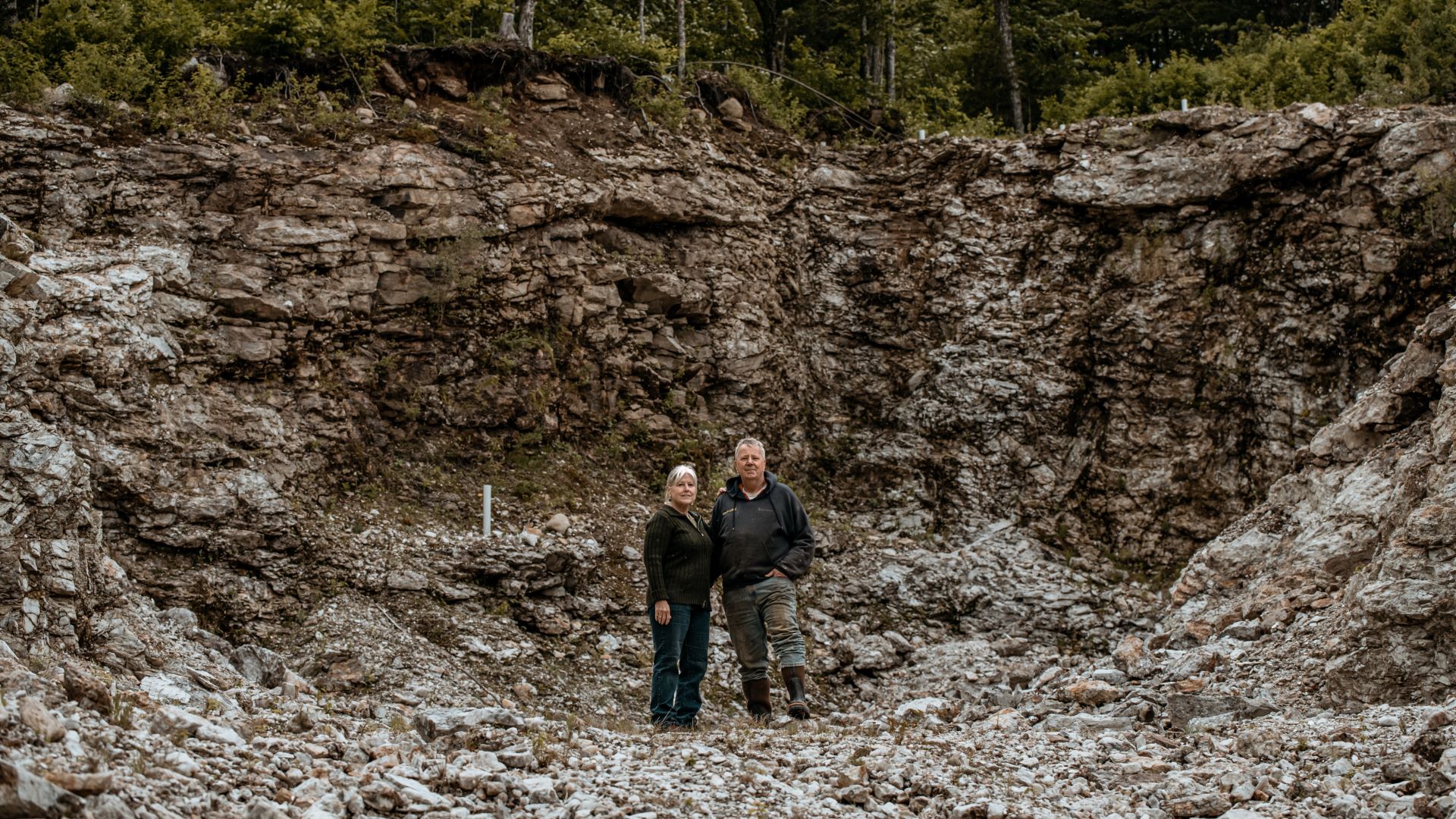 Mary and Gary Freeman pose for a photo in their test pit.