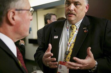 Philip Roy, on the right, speaks one on one with another man