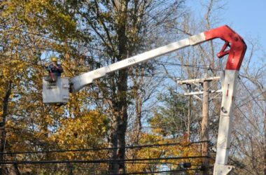 utility worker fixes power line