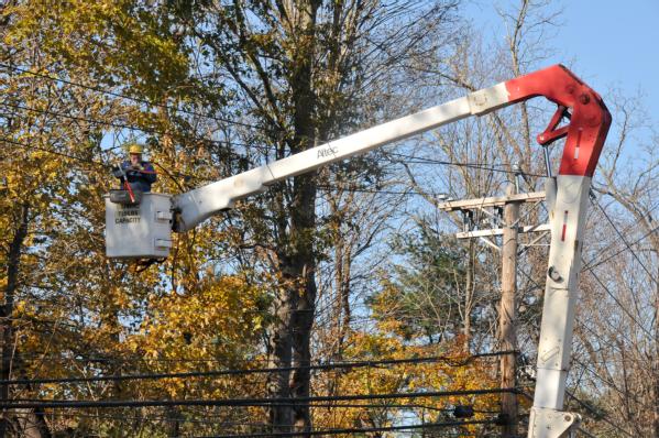 utility worker fixes power line