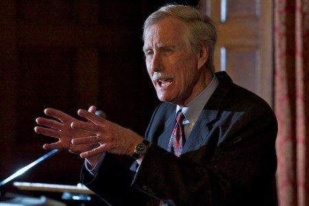 Angus King motions with his hands while speaking during an event.