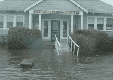 The exterior of the Memorial Library. The road in front of the library is underwater.