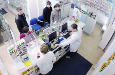 stock image of people being served by two pharmacists