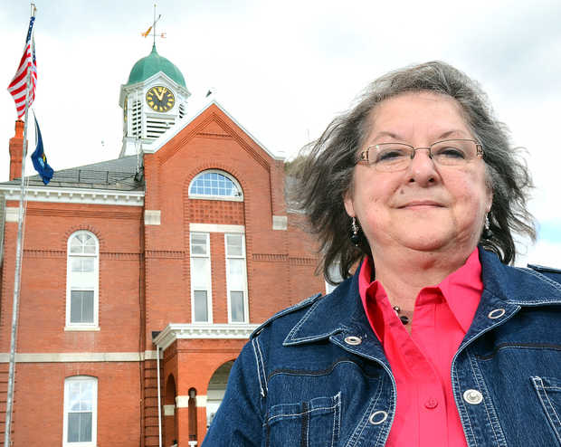 Mary Farrar stands outside a court house.