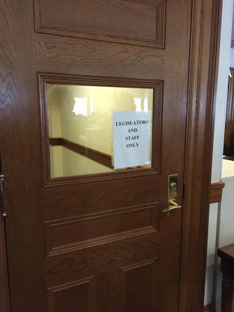Door at the back of the appropriations chamber for legislators and staff only