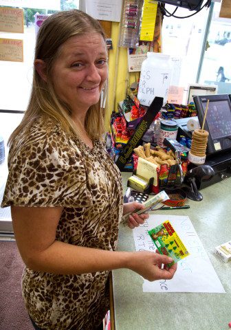 Karen Thayer, of Whitefield, Maine buys a $1 lottery ticket