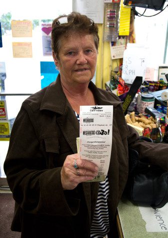 Lorraine Skidgel, of Randolph, purchases a Megabucks ticket 