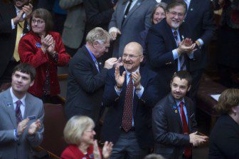 Maine lawmakers applauding in the House of Representatives 