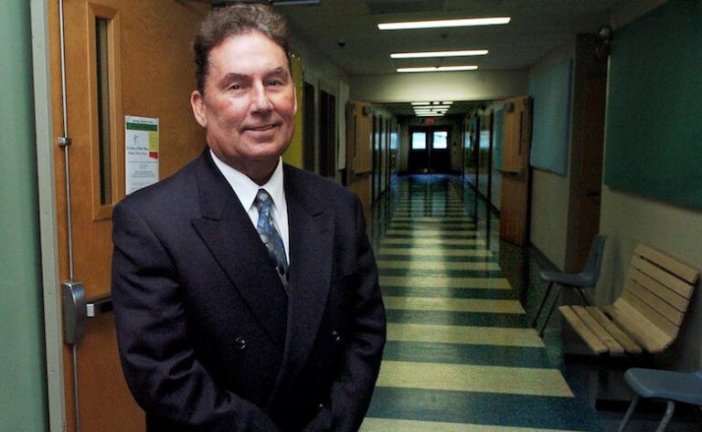 Tom Ward poses for a photo in a school hallway