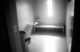 A black and white photo of the interior of an isolation cell at Maine State Prison.
