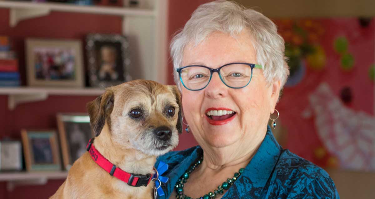 Mary Betterley poses for a photo with her dog