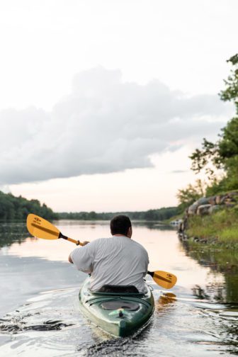 Jon Loring paddles along the Penobscot River at dusk. He often goes out canoeing or kayaking with his brother, Kris Loring, who also is in the healing court program. Photo by Greta Rybus.