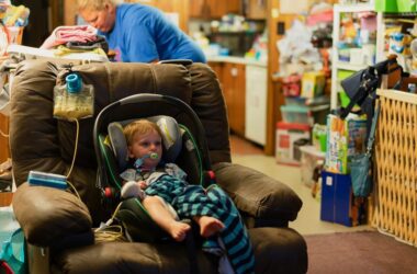 a baby sitting in a booster seat