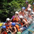 a group of people white water rafting.