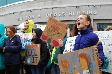 Students holding signs at a climate change rally.