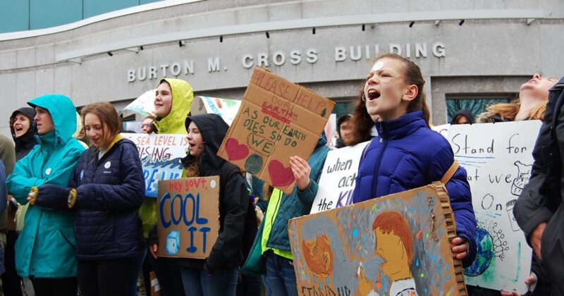 Students holding signs at a climate change rally.