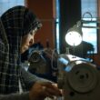 a woman operates a sewing machine