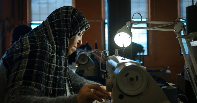 a woman operates a sewing machine