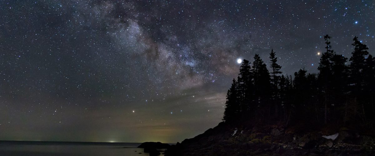 a coastal island at night under the stars