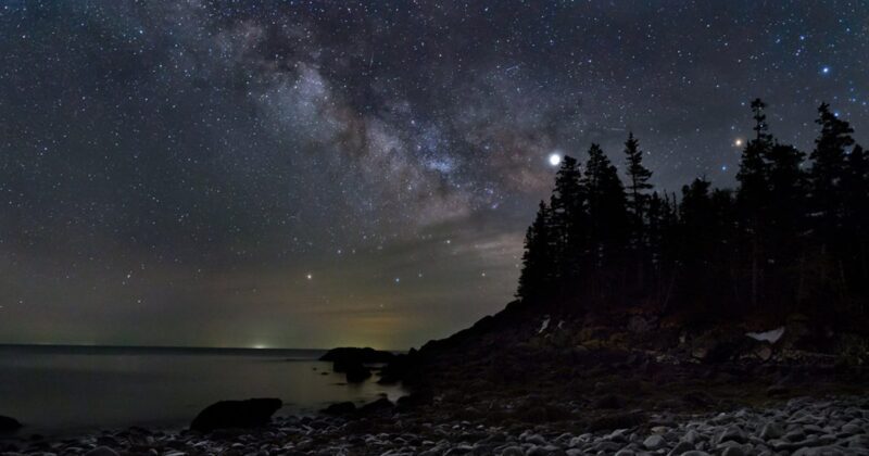a coastal island at night under the stars