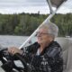 Sheri Oldham smiles while driving a boat.