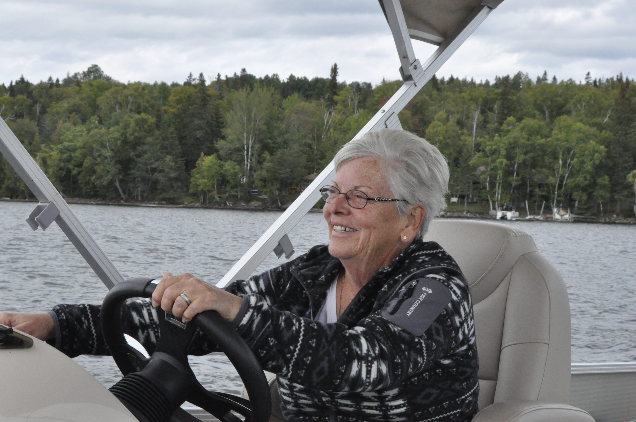 Sheri Oldham smiles while driving a boat.