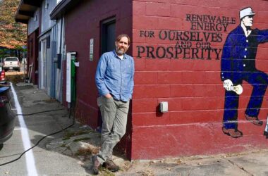 Vaughan Woodruff poses for a photo while leaning against a building.