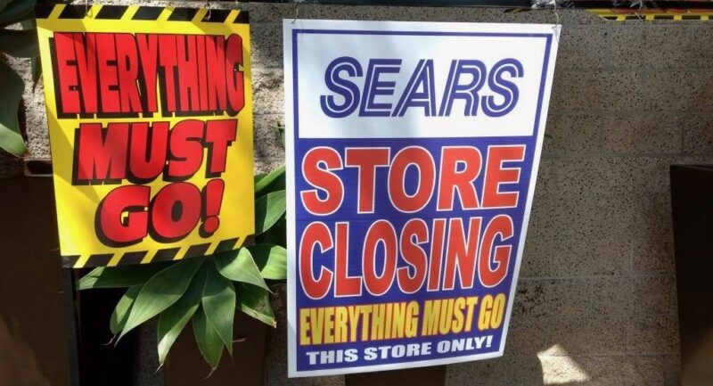 two signs about a sears location closing