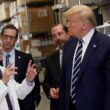 President Donald Trump listens to Dr. Anthony Fauci during a tour