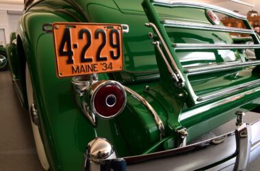 The front of a green 1934 Packard 1108 (Twelve) Sport Sedan by Dietrich with an orange Maine '34 license plate that reads 4-229.