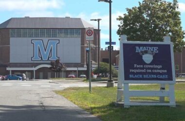 A sign at the University of Maine stating face coverings are required on the campus