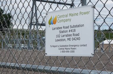 a sign on a fence noting the facility is the Central Maine Power Larrabee Road Substation in Lewiston