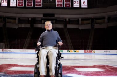 Travis Roy sits in his wheelchair on the ice at Boston University's arena.