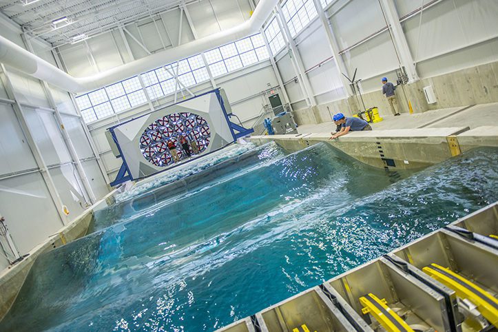 A wave tank is examined by researchers studying off-shore wind technology.