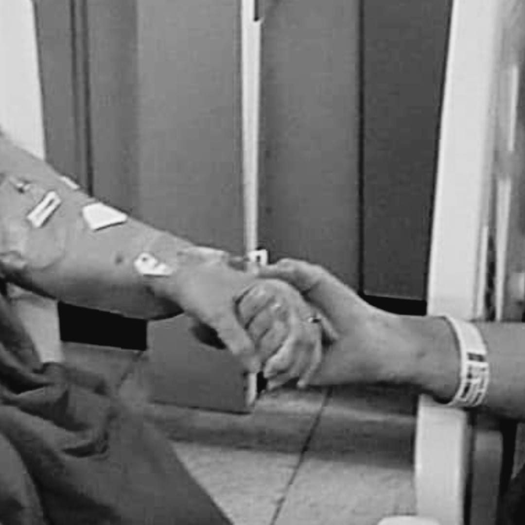 COVID patients hold hands in hospital