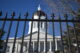 The dome of the Maine State House as shown through exterior fencing along the edge of the property.