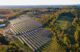 Solar power utility panels aerial view in Skowhegan Maine surrounded by trees