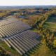 Aerial view of solar power utility panels surrounded by trees