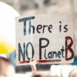 A climate activists hold a climate action sign that reads "There is no Planet B" in protest of emissions.