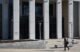 The exterior of the Capital Judicial Center. A man is walking towards the stairs of the building.