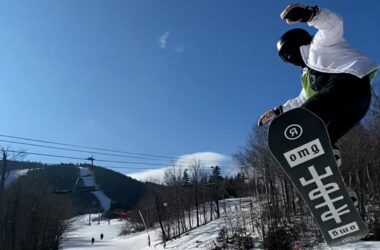 A snowboarder soars through the air.